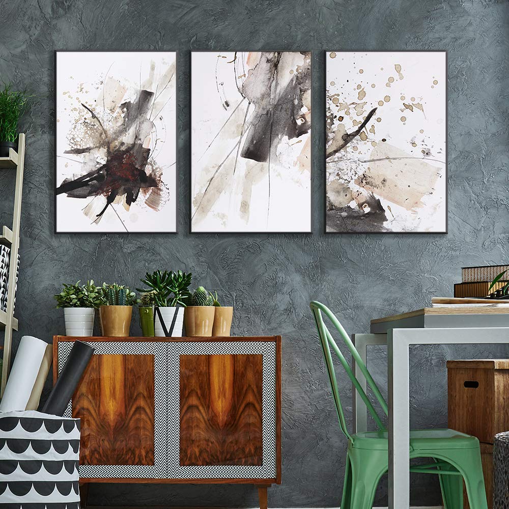 three rectangular art canvases with light brown and dark gray splashes