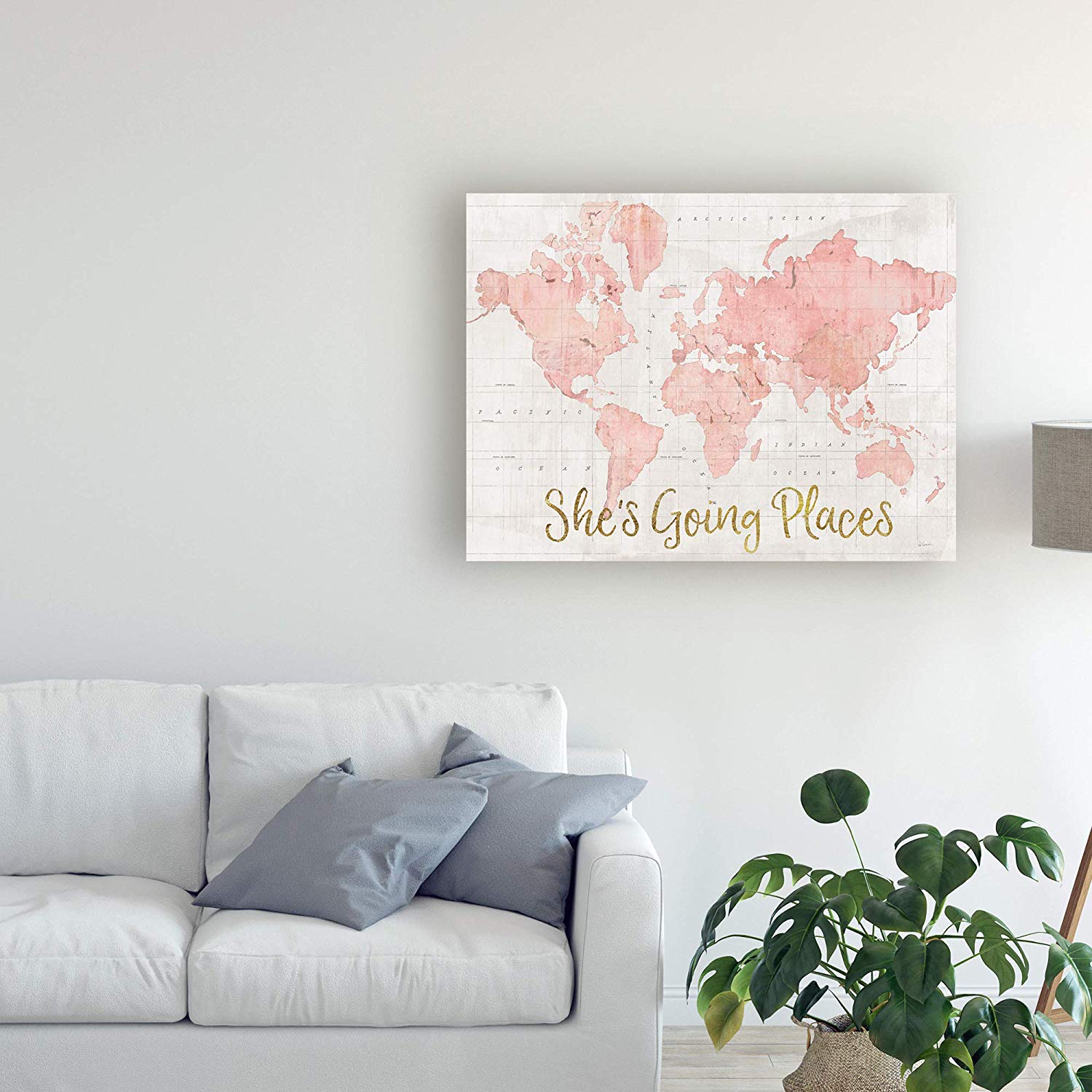 canvas art with pink world map and quote that says she's going places