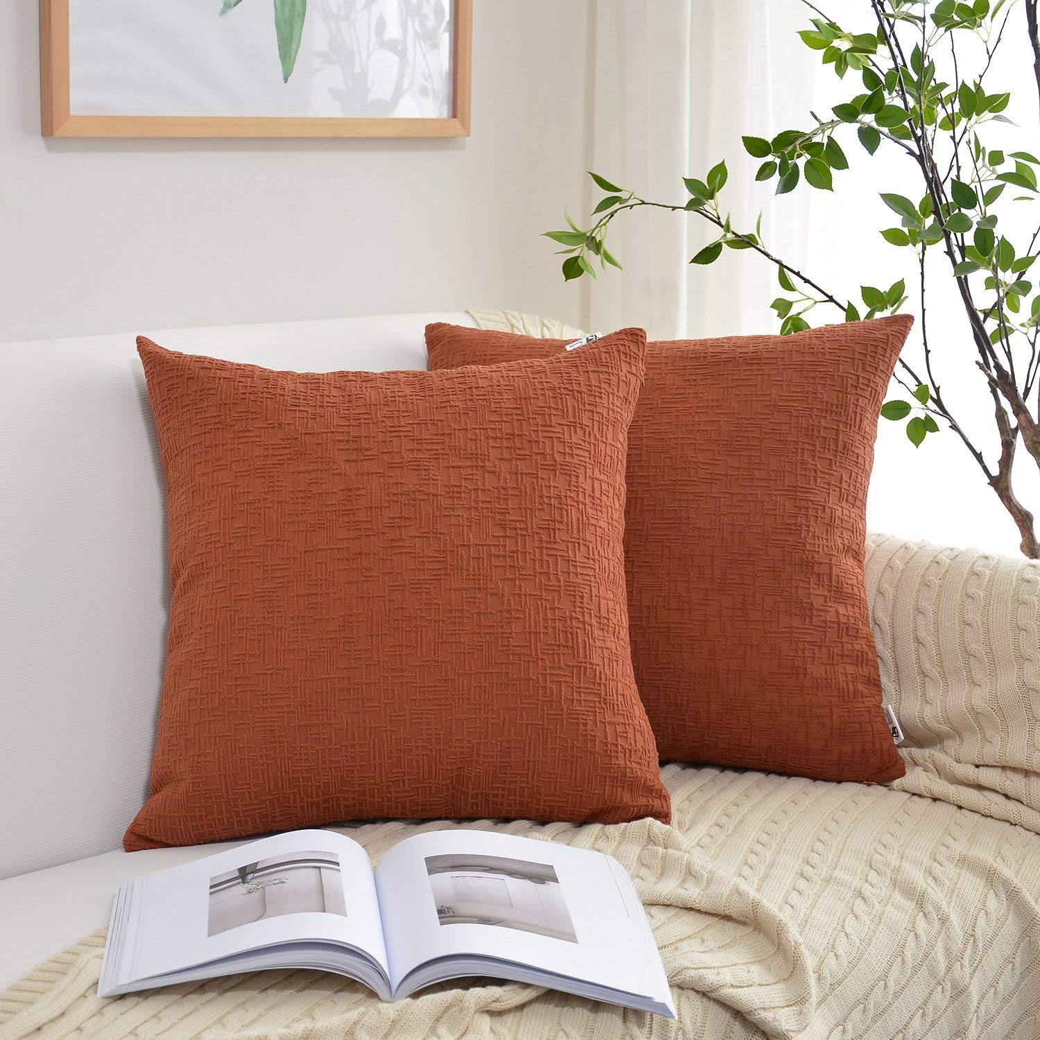 two square terracotta colored pillow covers