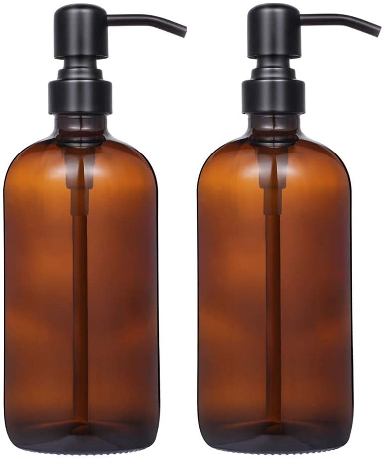 two brown glass soap dispensers with black pumps