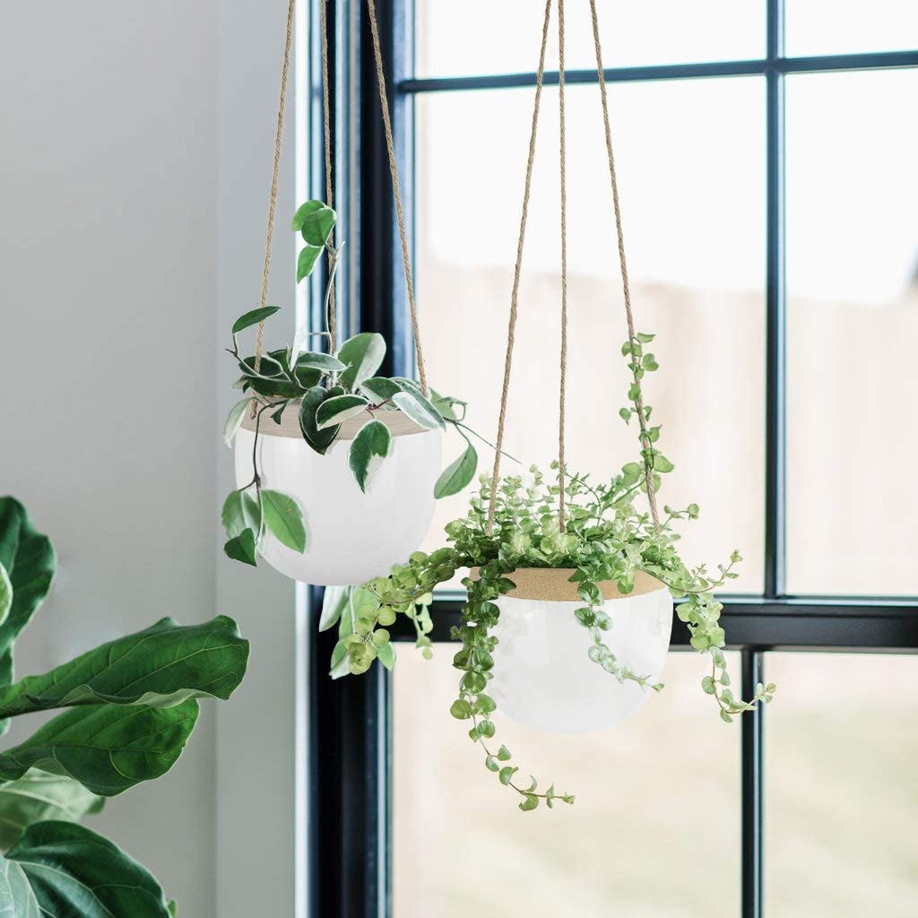 hanging white pots with light brown trim and ropes to hang