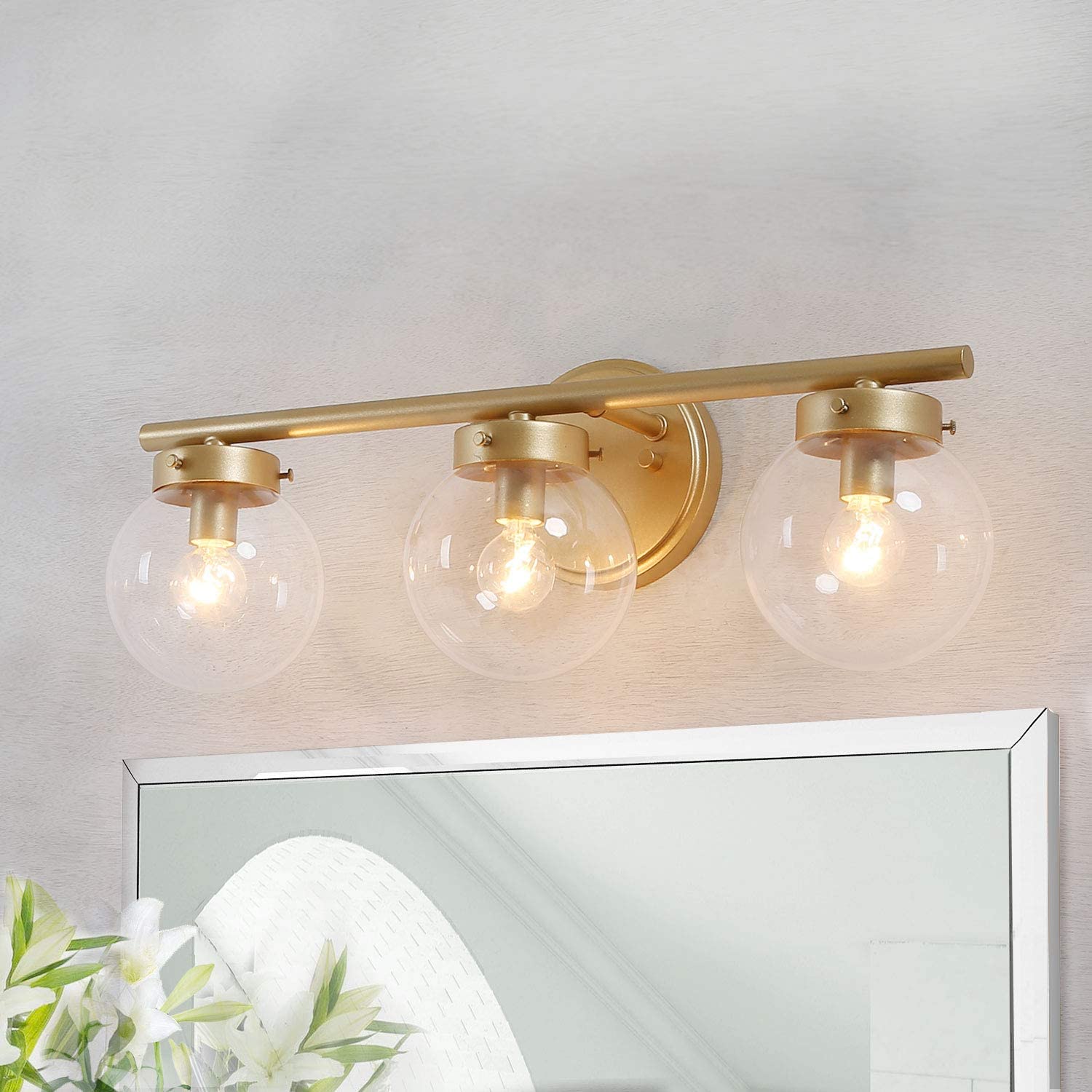 modern gold light fixture with big round glass shades