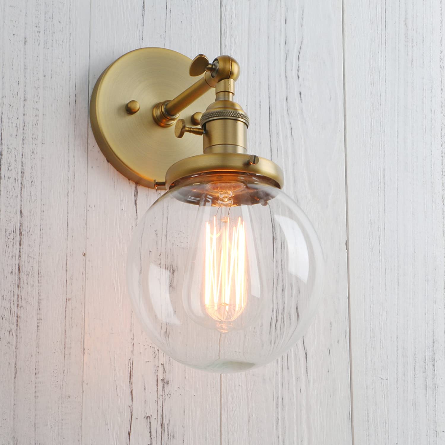 modern gold sconce with round glass shade